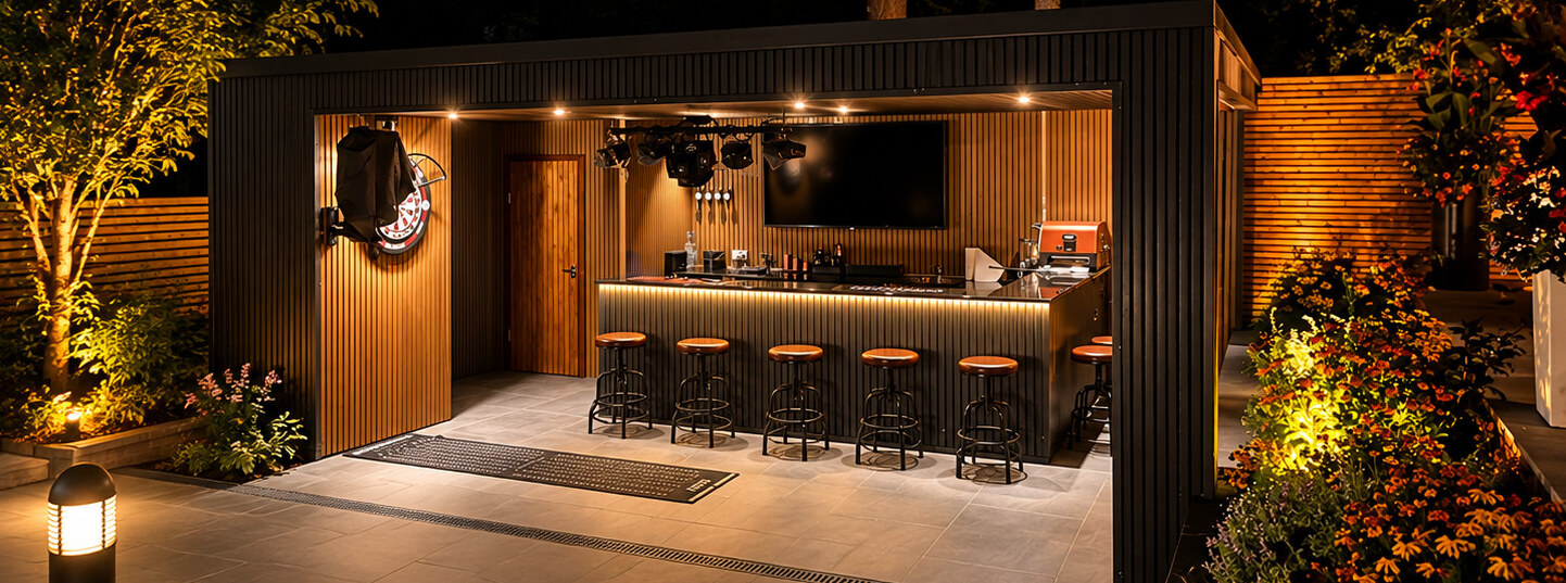 Covered outdoor bar and entertaining space with slatted timber cladding and warm lighting